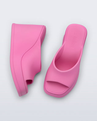 Top and side view of a pair of pink Free Slip platform wedge heels