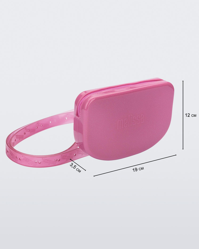 Angled view of the pink Melissa Go Easy Bag with strap with bag dimensions 19 cm length, 3.5 cm width, and 12 cm height.