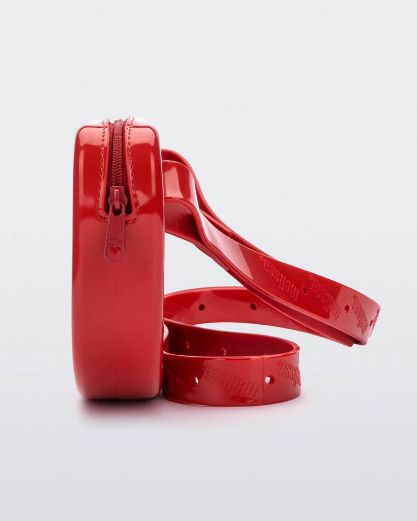 Side view of the red Melissa Go Easy Bag with strap
