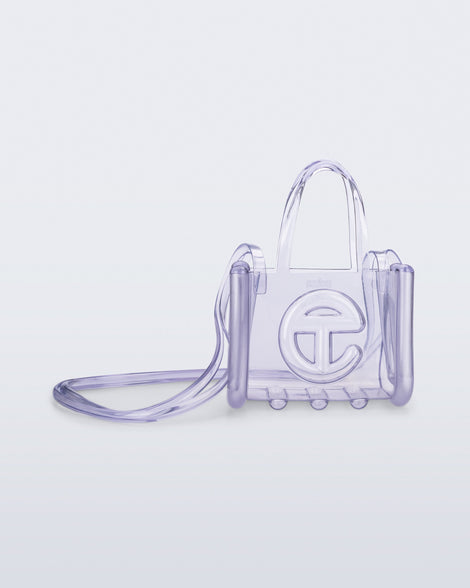 Front view of a clear Melissa Small Jelly Shopper + Telfar bag with handles and a body strap