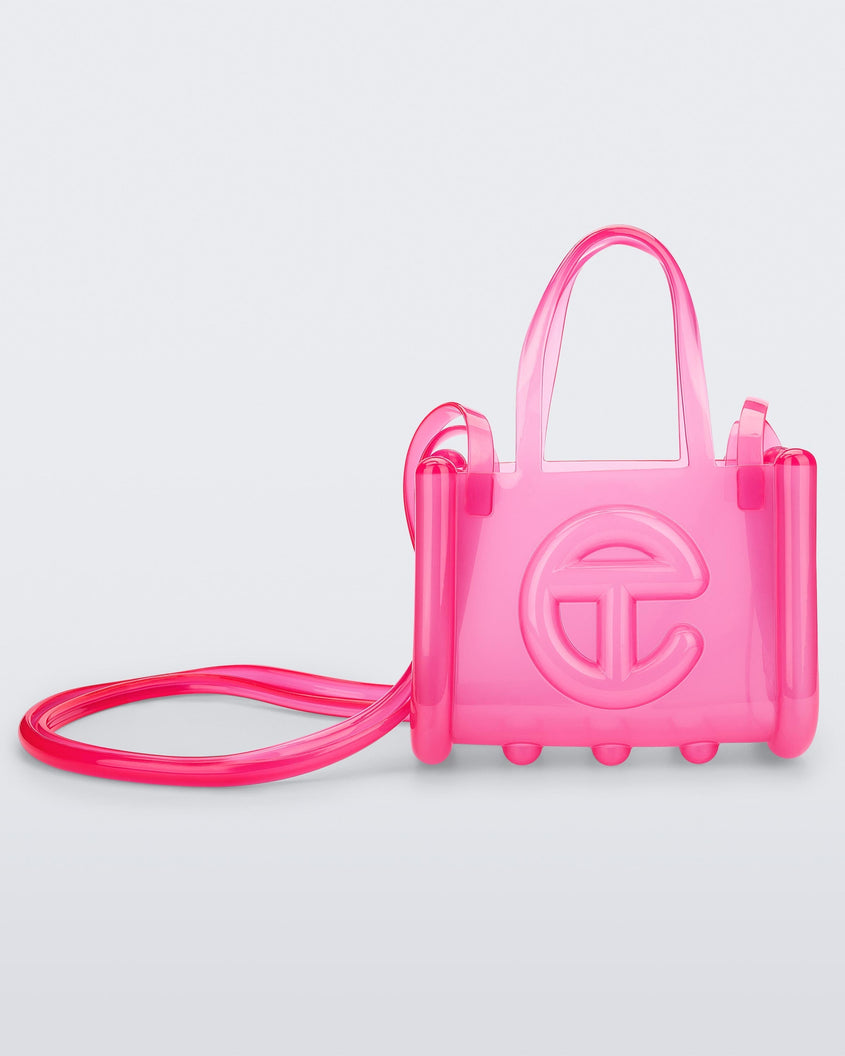 Front view of a pink small Melissa Jelly Shopper bag + Telfar bag with a handle and straps.