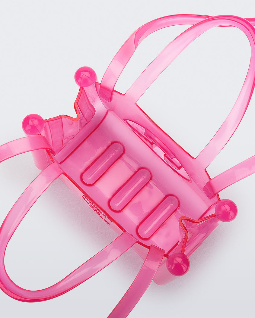 Top view of a pink small Melissa Jelly Shopper bag + Telfar bag with a handle and straps.