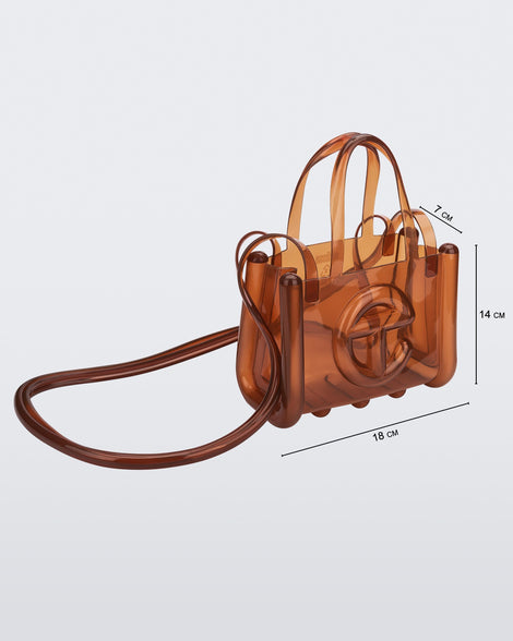 Angled view of a brown small Melissa Jelly Shopper bag + Telfar bag with a handle and straps. Dimensions 18 cm length, 7 cm width, 14 cm height