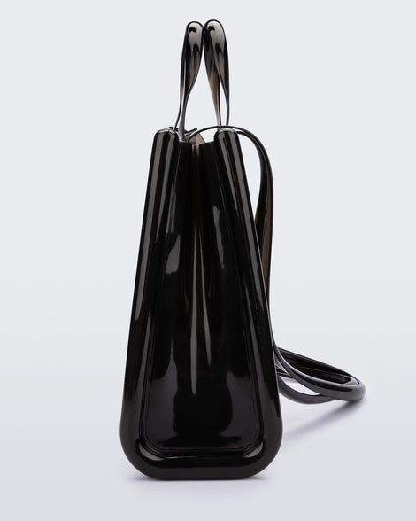 Side view of a black large Melissa Jelly Shopper bag + Telfar bag with a handle and straps.