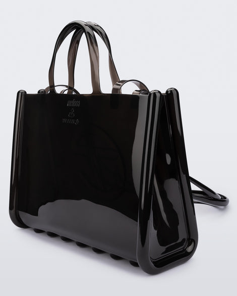Angled view of a black large Melissa Jelly Shopper bag + Telfar bag with a handle and straps.