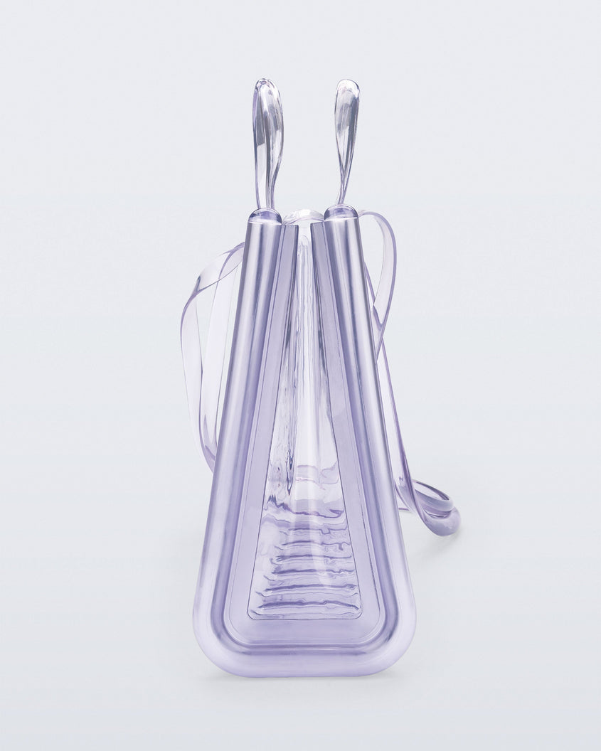 Side view of a clear Melissa Large Jelly Shopper + Telfar bag with handles and a body strap