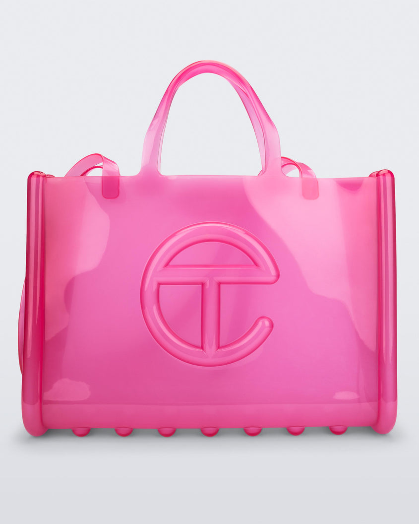 Front view of a pink large Melissa Jelly Shopper bag + Telfar bag with a handle and straps.
