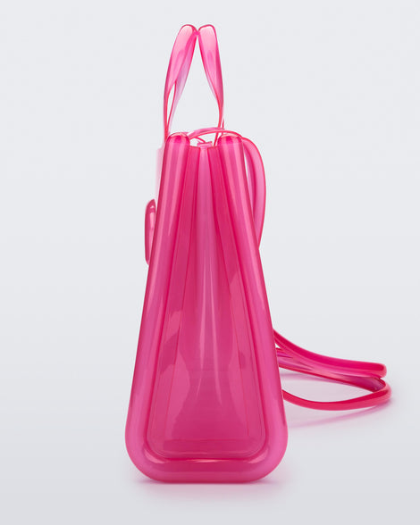 Side view of a pink large Melissa Jelly Shopper bag + Telfar bag with a handle and straps.