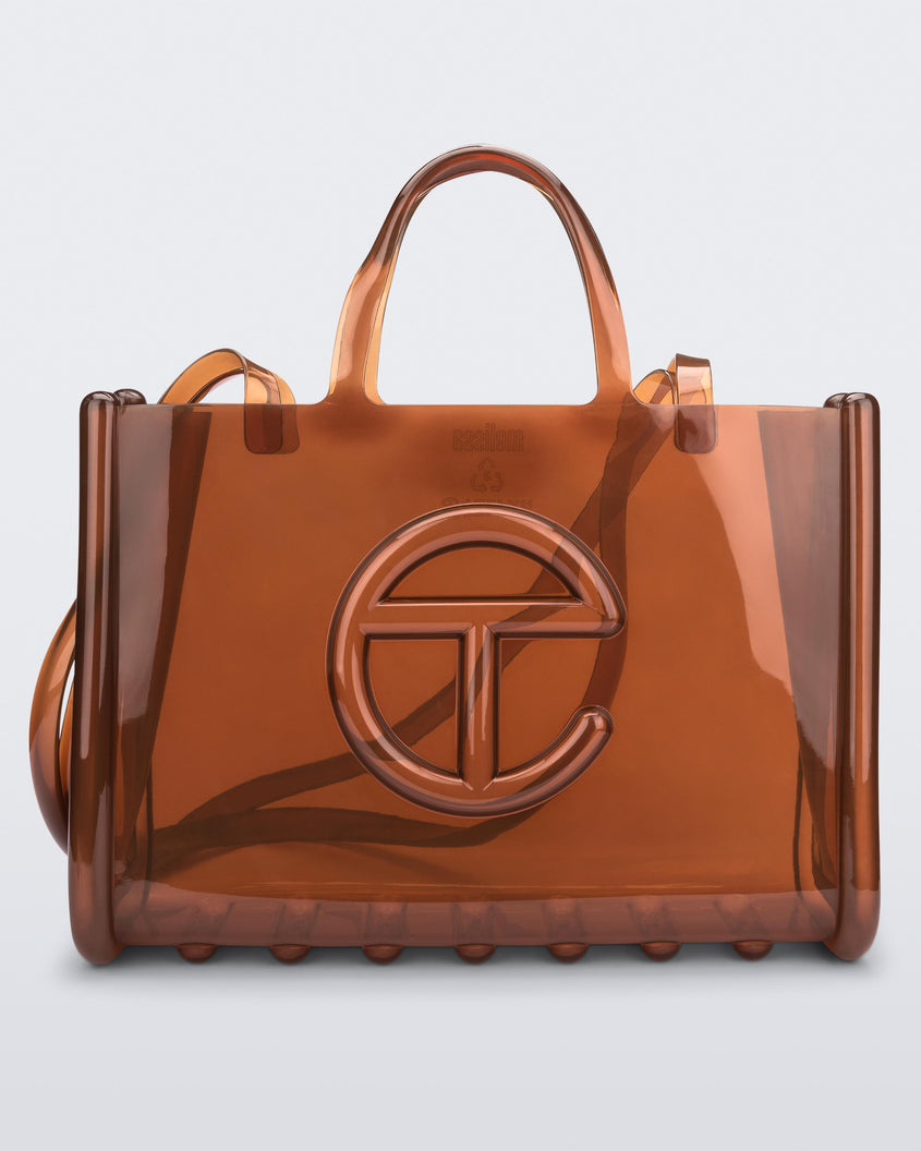 Front view of a brown large Melissa Jelly Shopper bag + Telfar bag with a handle and straps.