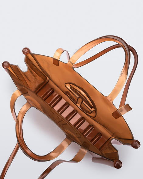 Top view of a brown large Melissa Jelly Shopper bag + Telfar bag with a handle and straps.