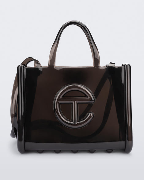Front view of a black medium Melissa Jelly Shopper bag + Telfar bag with a handle and straps.