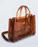 Angled view of a brown medium Melissa Jelly Shopper bag + Telfar bag with a handle and straps.