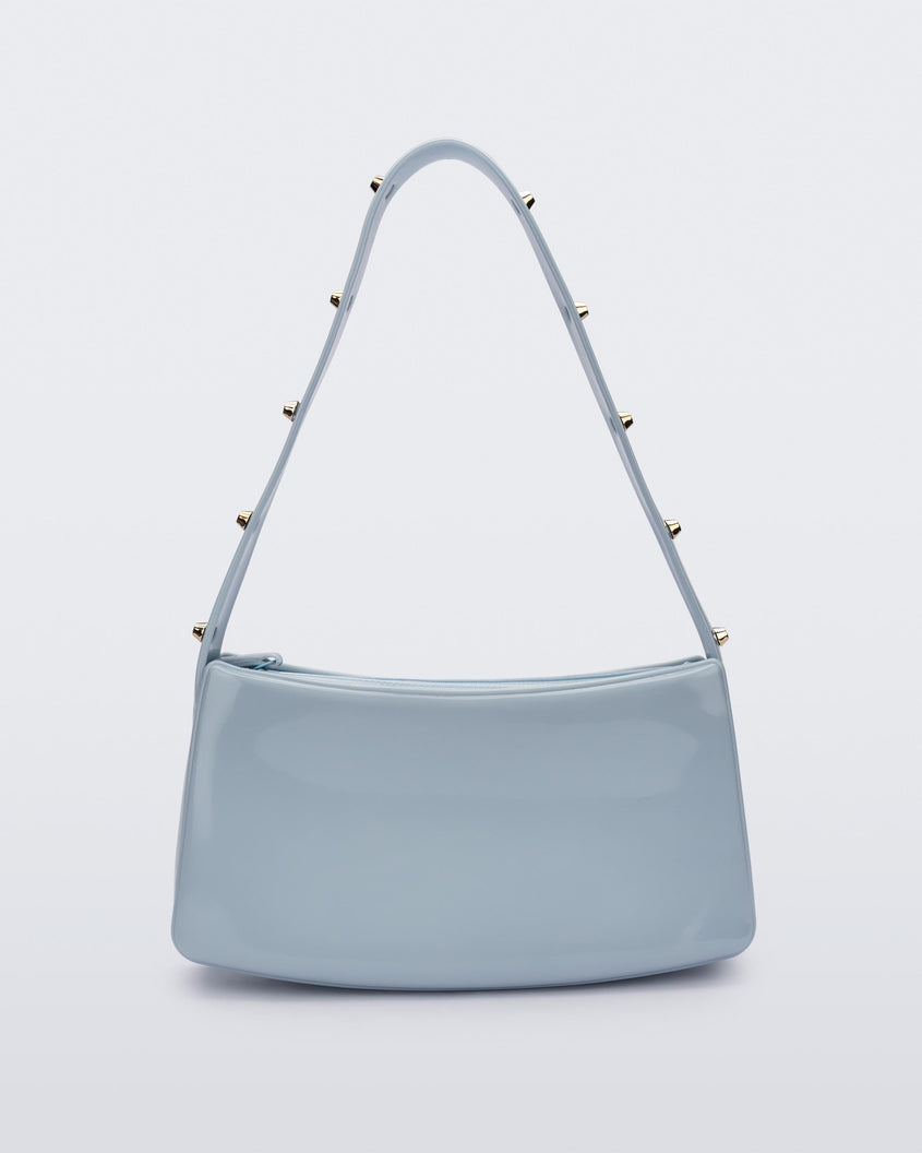 Back view of the blue Melissa Baguete Studs bag with a short studded strap.