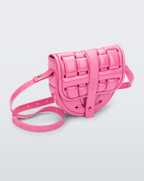 Angled front view of a pink Possession Bag with strap.