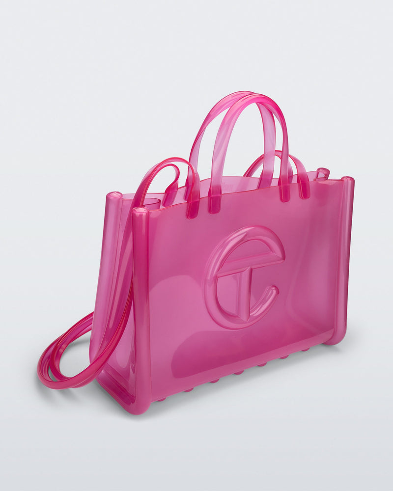 Angled view of the pink Large Jelly Shopper x Telfar bag
