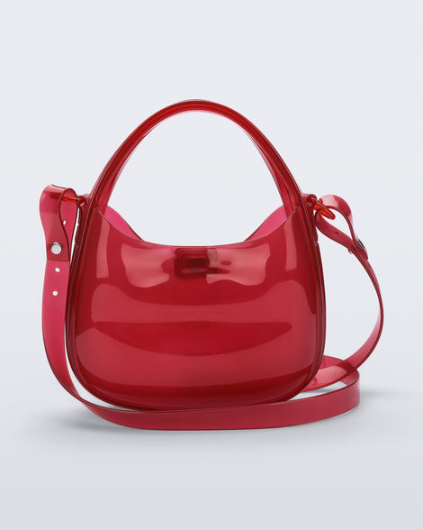 Back view of a clear red Mirror bag with cross body straps two clear handles.