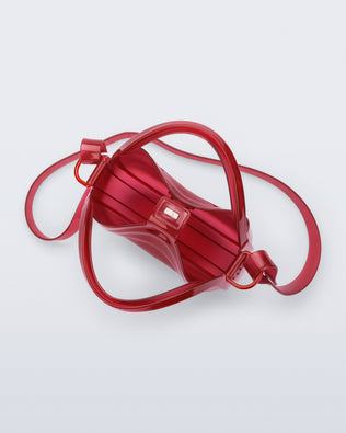 Top view of a clear red Mirror bag with cross body straps two clear handles.