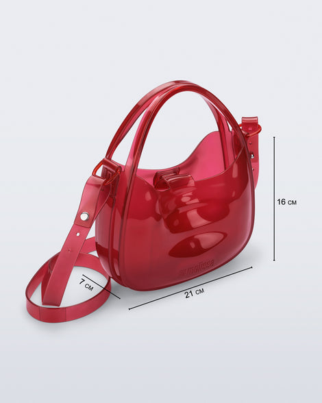Front view of a clear red Mirror bag with cross body straps two clear handles with bag dimensions 21cm x 7cm x 16cm