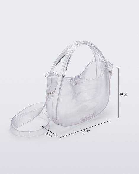 Angled view of a clear Mirror bag with cross body straps two clear handles and bag dimensions of 21cm x 7cm x 16cm