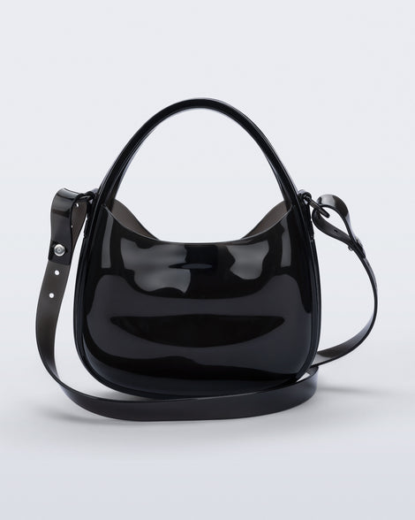 Back view of a clear black Mirror bag with cross body straps two clear handles.