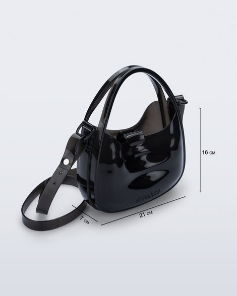 Angled view of a clear black Mirror bag with cross body straps two clear handles with bag dimensions 21cm x 7cm x 16cm