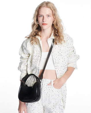 model wearing a clear black Mirror bag with cross body straps two clear handles.