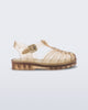 Side view of a clear beige Possession baby sandal