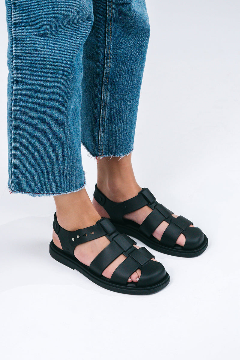 Model's legs in cut off jeans wearing a pair of black Emma women's 