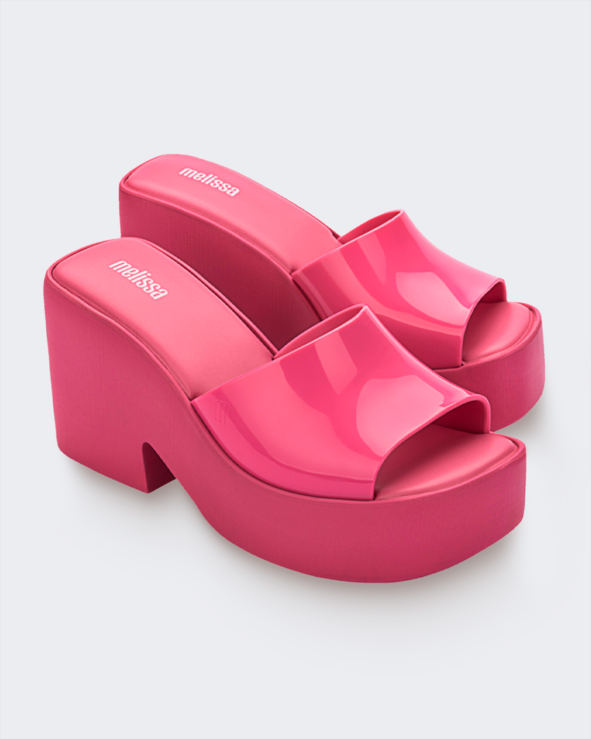 Side view of a pair of pink Melissa Posh platform slide heels