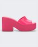An outer side view of a pink Melissa Posh platform slide heel