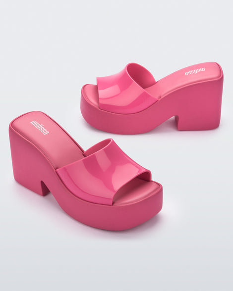 Outside and Inside view of a pair of Melissa Posh platform slides in pink