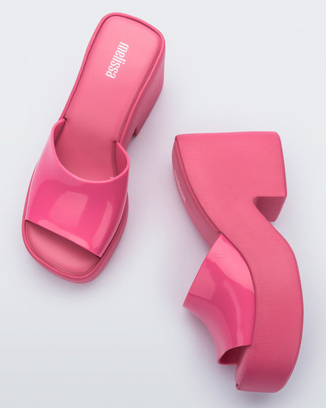 Top and side view of a pair of Melissa Posh platform slides in pink
