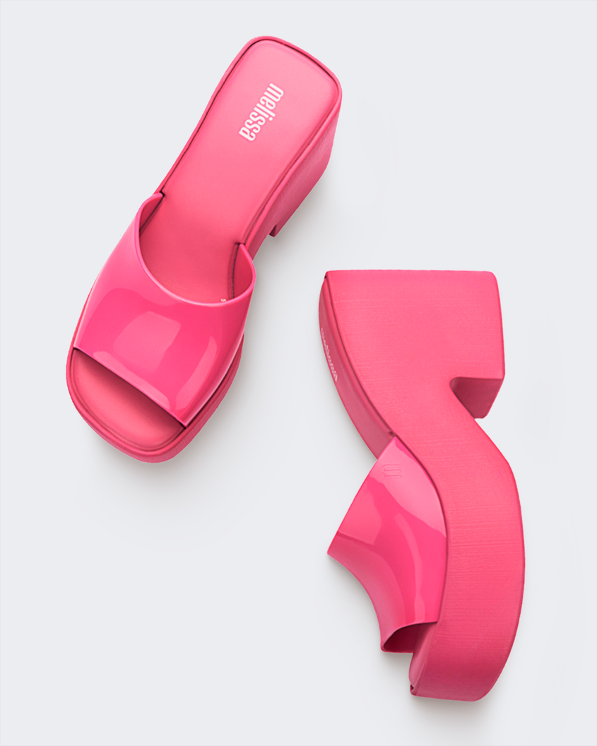 A top and side view of a pair of pink Melissa Posh platform slide heels