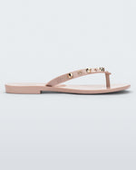 Side view of a pink Melissa Harmonic Studs flip flop with gold studs on the upper.