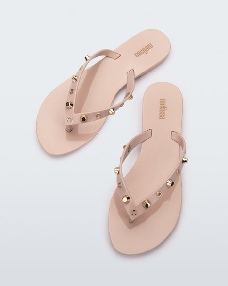 Top view of a pair of pink Melissa Harmonic Studs flip flops with gold studs on the upper.