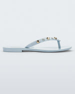 Side view of a blue Melissa Harmonic Studs flip flop with gold studs on the upper.