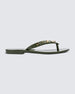 Side view of a green Melissa Harmonic Studs flip flop with gold studs on the upper.