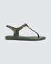 Side view of a green Melissa Solar studs sandal with gold studded t-strap and gold buckle.