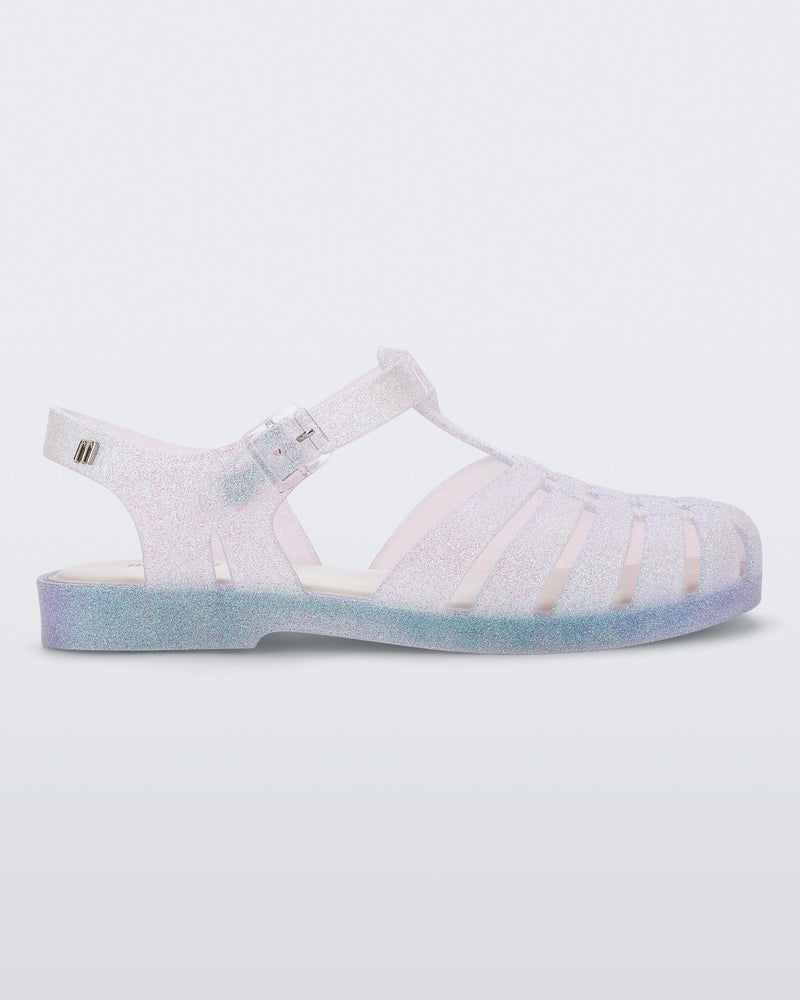 Side view of a clear glitter Possession Sandal.