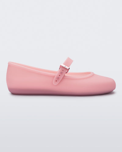 Side view of a milky pink Soft Ballerina flat with a strap and buckle