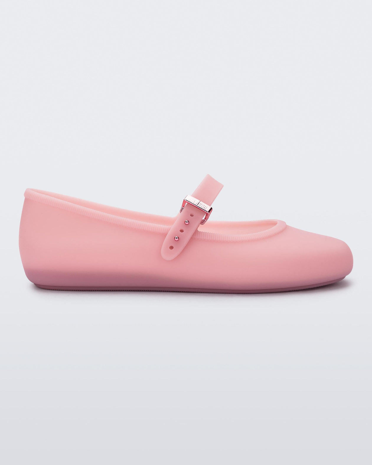 Side view of a milky pink Soft Ballerina flat with a strap and buckle