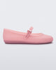 Side view of a milky pink Soft Ballerina flat with a strap and buckle