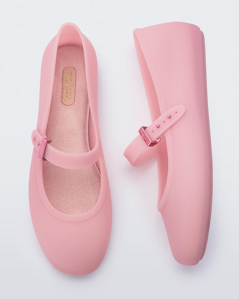 Top and side view of a pair of milky pink Soft Ballerina flats with a strap and buckle