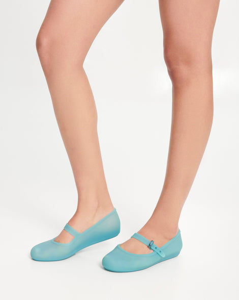 Model's legs wearing a pair of milky blue Soft Ballerina flats