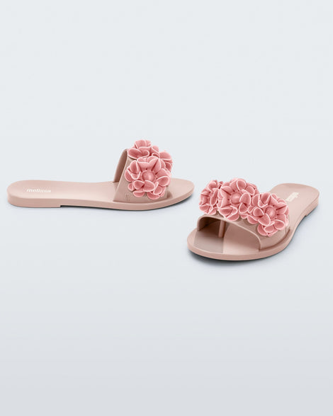Side and angled view of a pair of pink Babe Springtime women's slide with 3 pink flowers.