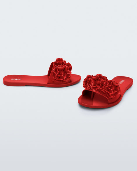 Angled view of a pair of red Babe Springtime women's slide with 3 red flowers.