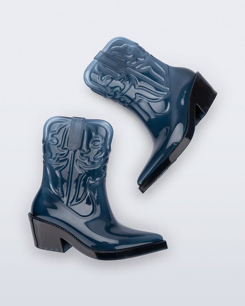 Side view of a pair of transparent blue Texas Boots with pointed toe and black sole