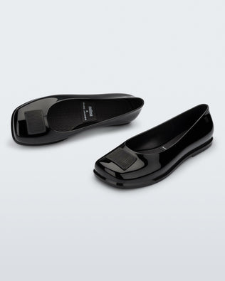 Top and angled view of a pair of black Ruby + Marc Jacobs flats