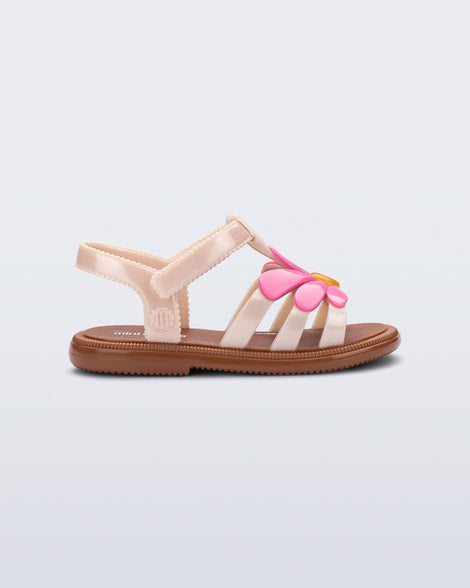 Side view of a pink Hip Bloom kids sandal with pink flower 