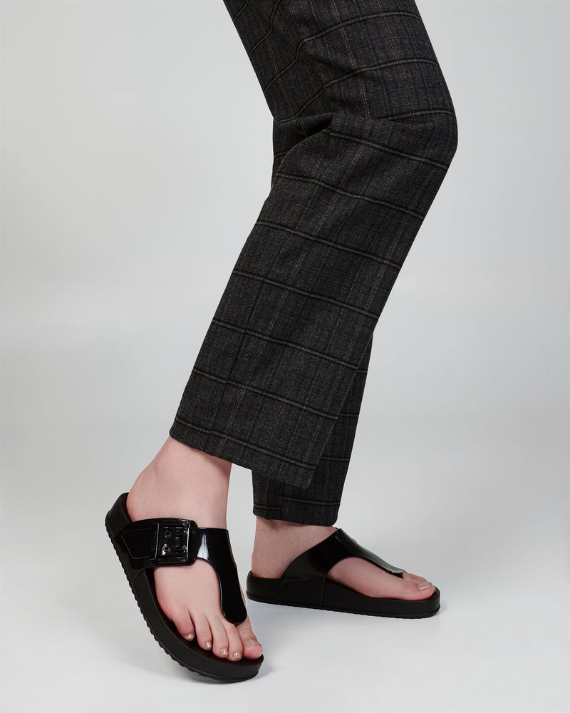Model's legs wearing a pair of black Cozy Flip flops